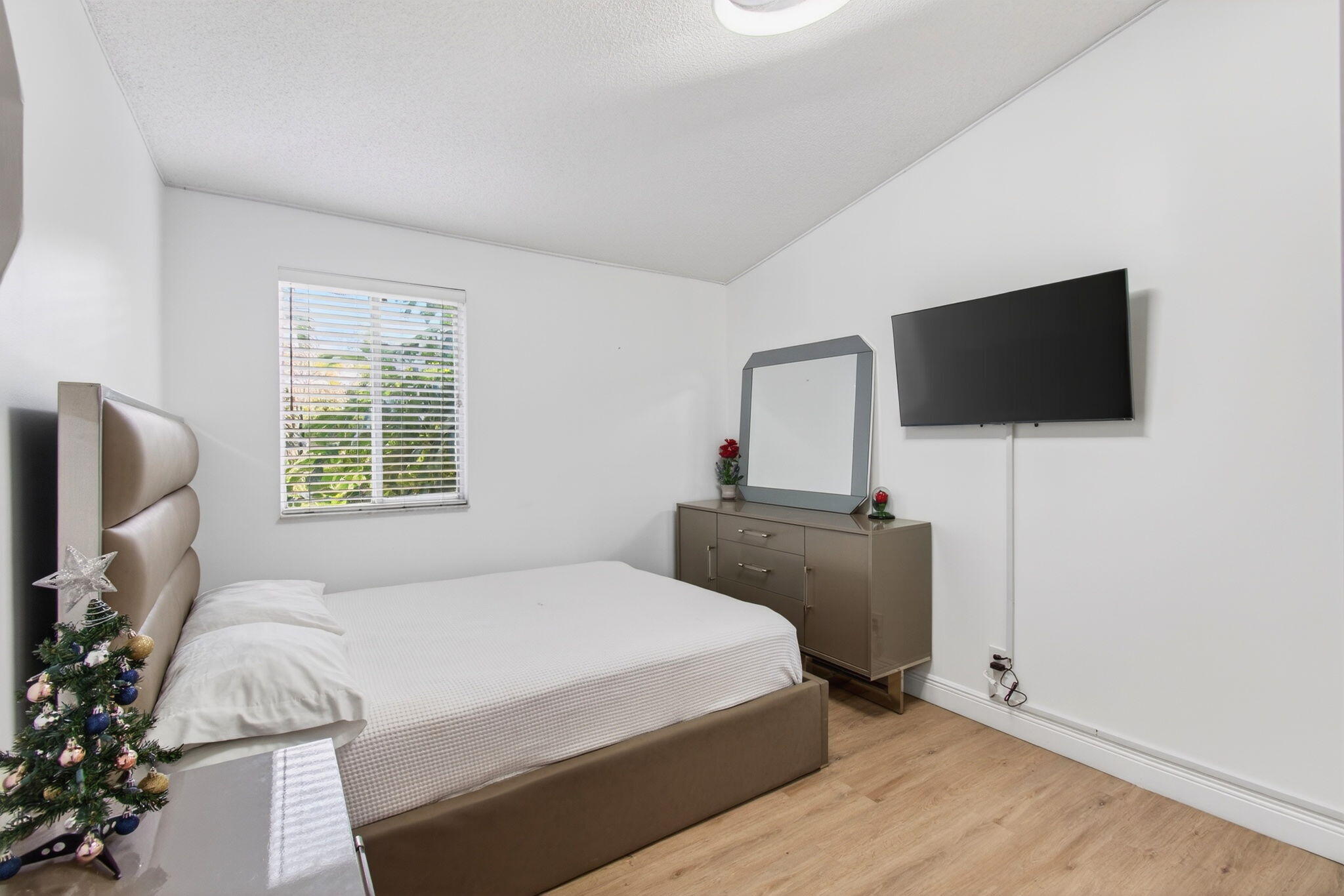 6766 Via Regina Boca Raton, FL 33433 - Photo 28 of 57 a bedroom with a bed and a flat screen tv