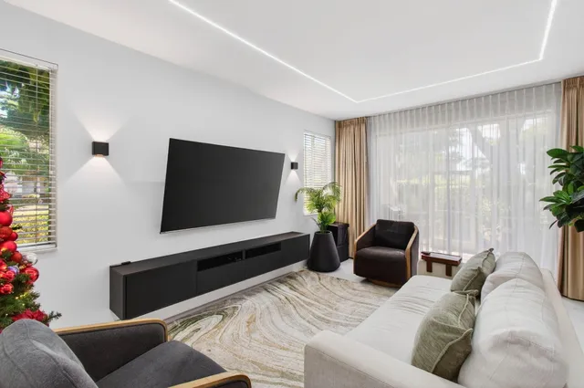 a living room with furniture and flowers