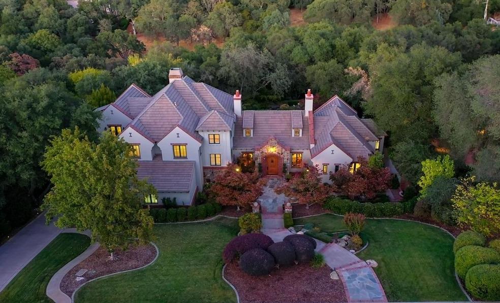 an aerial view of a house with a garden and trees