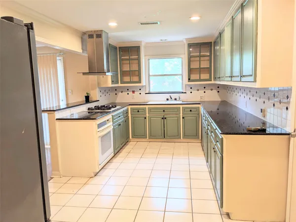 a kitchen with a stove a sink and a refrigerator