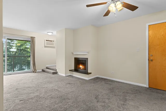 an empty room with a ceiling fan and a window