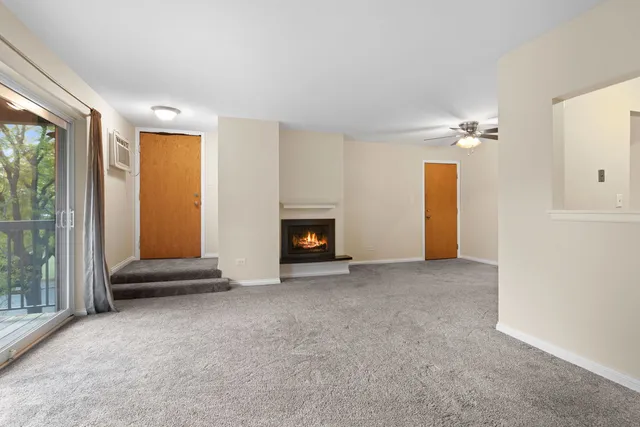 a view of an empty room with a fireplace