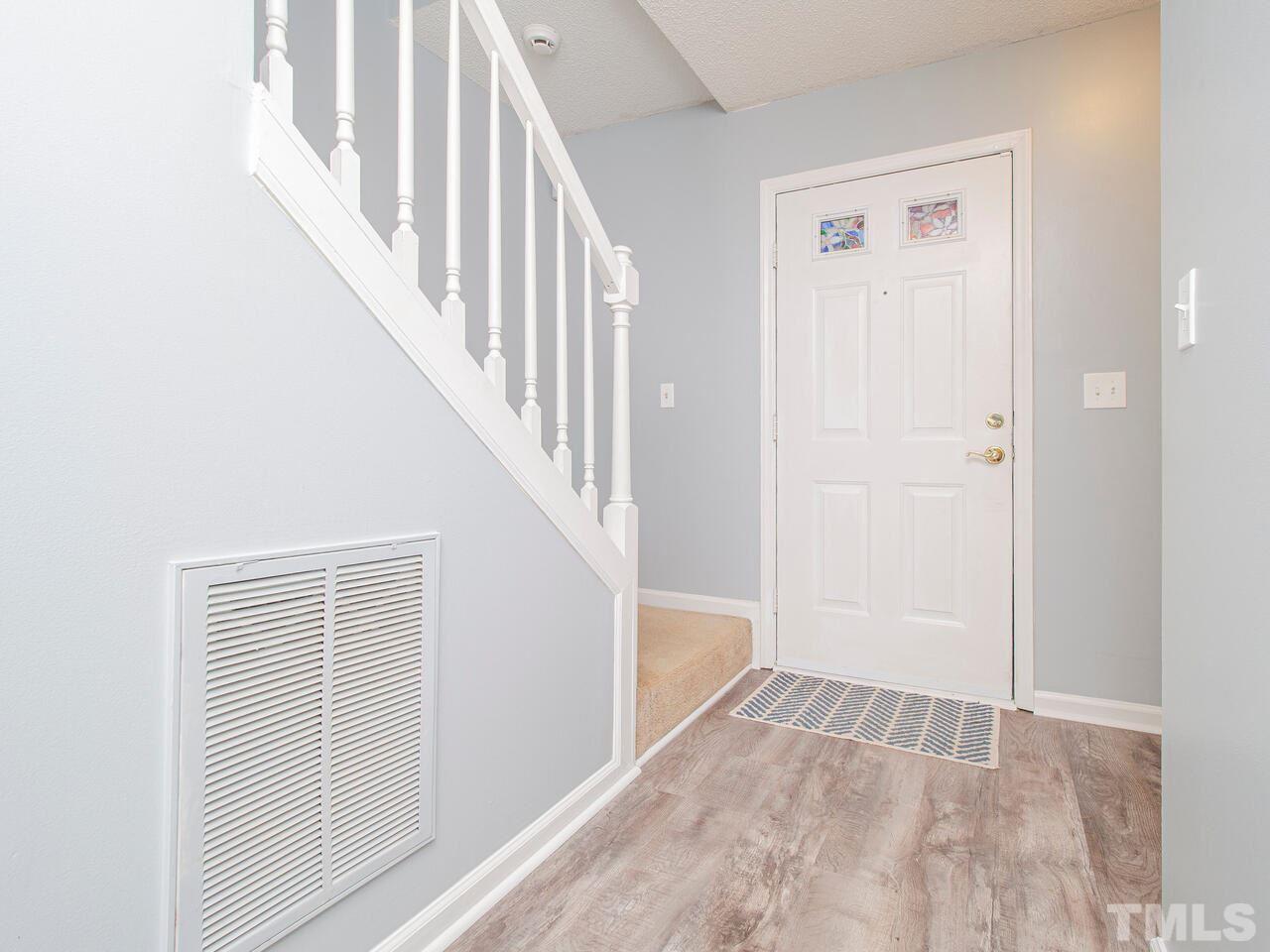 3540 Tunas Street Raleigh, NC 27616 - Photo 4 of 24 a view of staircase with white walls and white door
