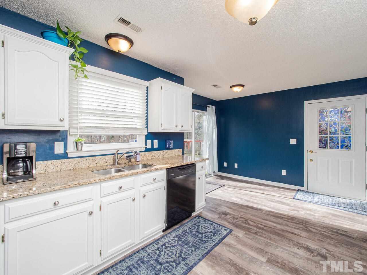 3540 Tunas Street Raleigh, NC 27616 - Photo 9 of 24 a kitchen with a sink cabinets and window