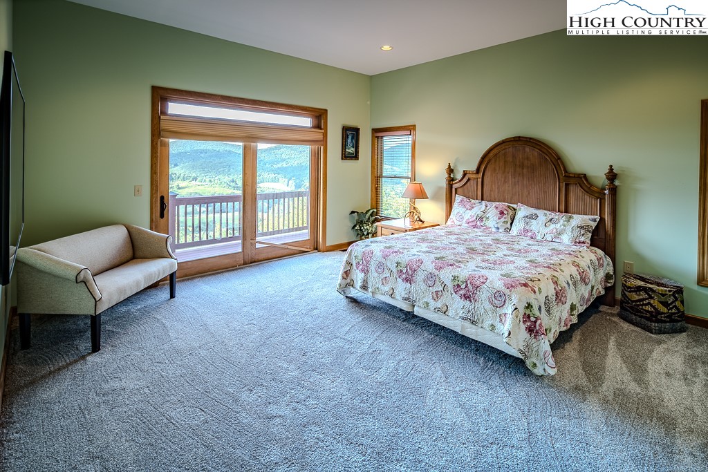196 Hanley Lane Boone, NC 28607 - Photo 12 of 27 a bedroom with a bed and a couch