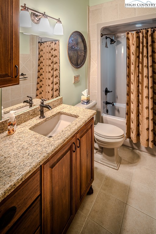 196 Hanley Lane Boone, NC 28607 - Photo 17 of 27 a bathroom with a granite countertop sink mirror vanity and toilet