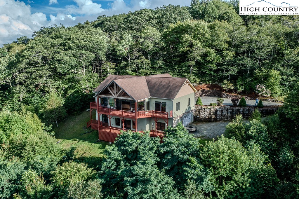 196 Hanley Lane Boone, NC 28607 - Photo 2 of 27 an aerial view of a house with a big yard and large trees
