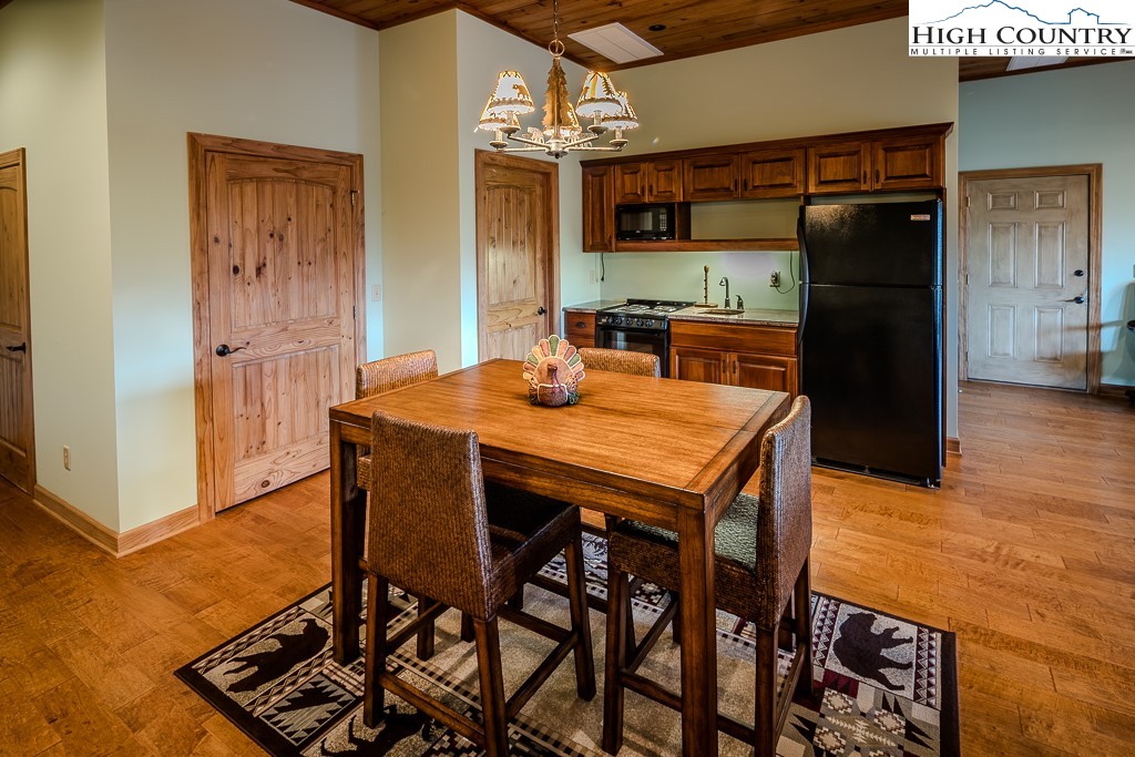 196 Hanley Lane Boone, NC 28607 - Photo 21 of 27 a kitchen with stainless steel appliances kitchen island granite countertop a refrigerator and microwave