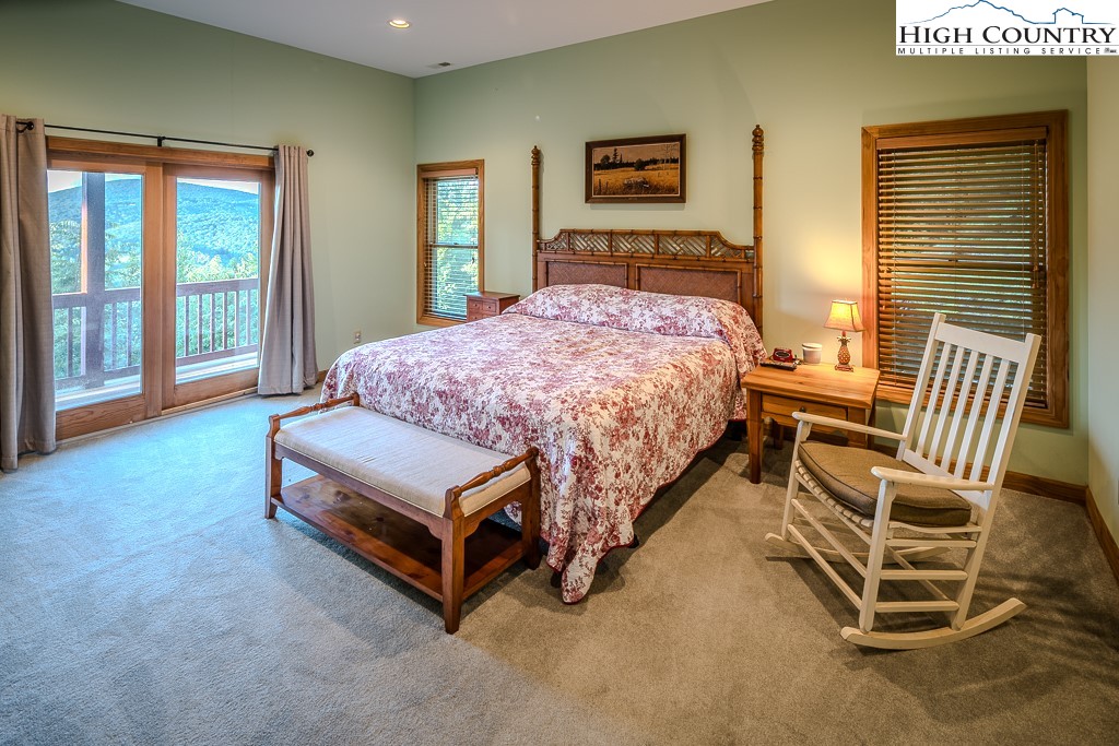 196 Hanley Lane Boone, NC 28607 - Photo 23 of 27 a bedroom with a bed chair and window
