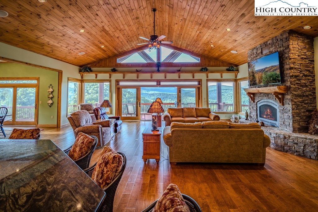 196 Hanley Lane Boone, NC 28607 - Photo 5 of 27 a living room with furniture a fireplace and a large window