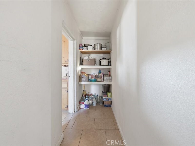 19876 Lodema Road Apple Valley, CA 92307 - Photo 16 of 40 a view of a hallway with shelf