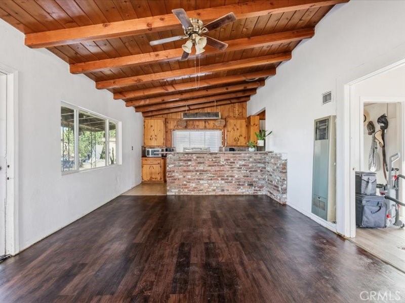 19876 Lodema Road Apple Valley, CA 92307 - Photo 2 of 40 a view of an empty room with wooden floor and a window