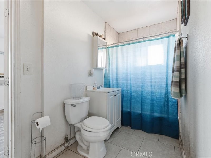 19876 Lodema Road Apple Valley, CA 92307 - Photo 4 of 40 a bathroom with a toilet a sink and shower