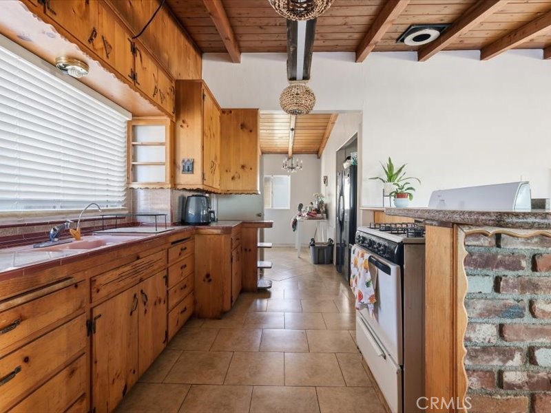 19876 Lodema Road Apple Valley, CA 92307 - Photo 7 of 40 a kitchen with stainless steel appliances kitchen island granite countertop a sink and cabinets