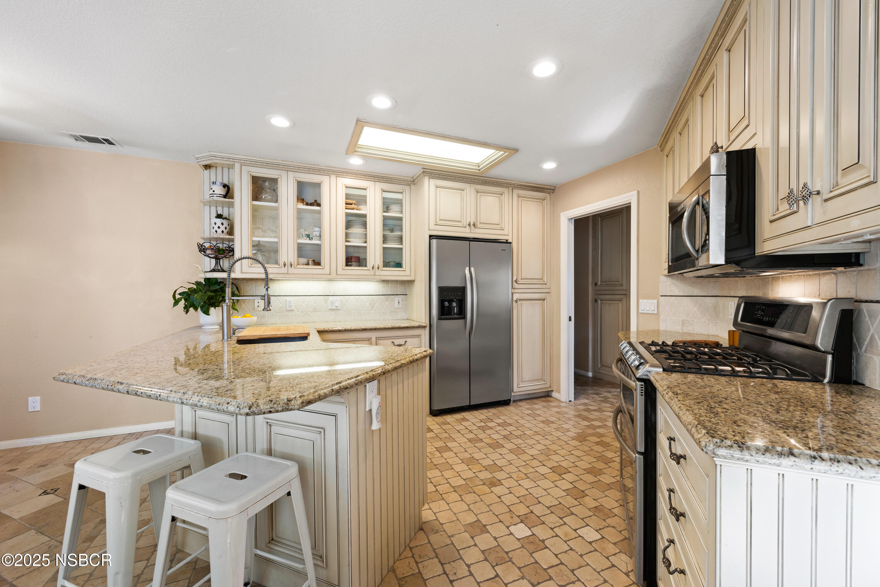 922 College Canyon Road Solvang, CA 93463 - Photo 5 of 23 a kitchen with stainless steel appliances granite countertop a stove refrigerator sink and cabinets