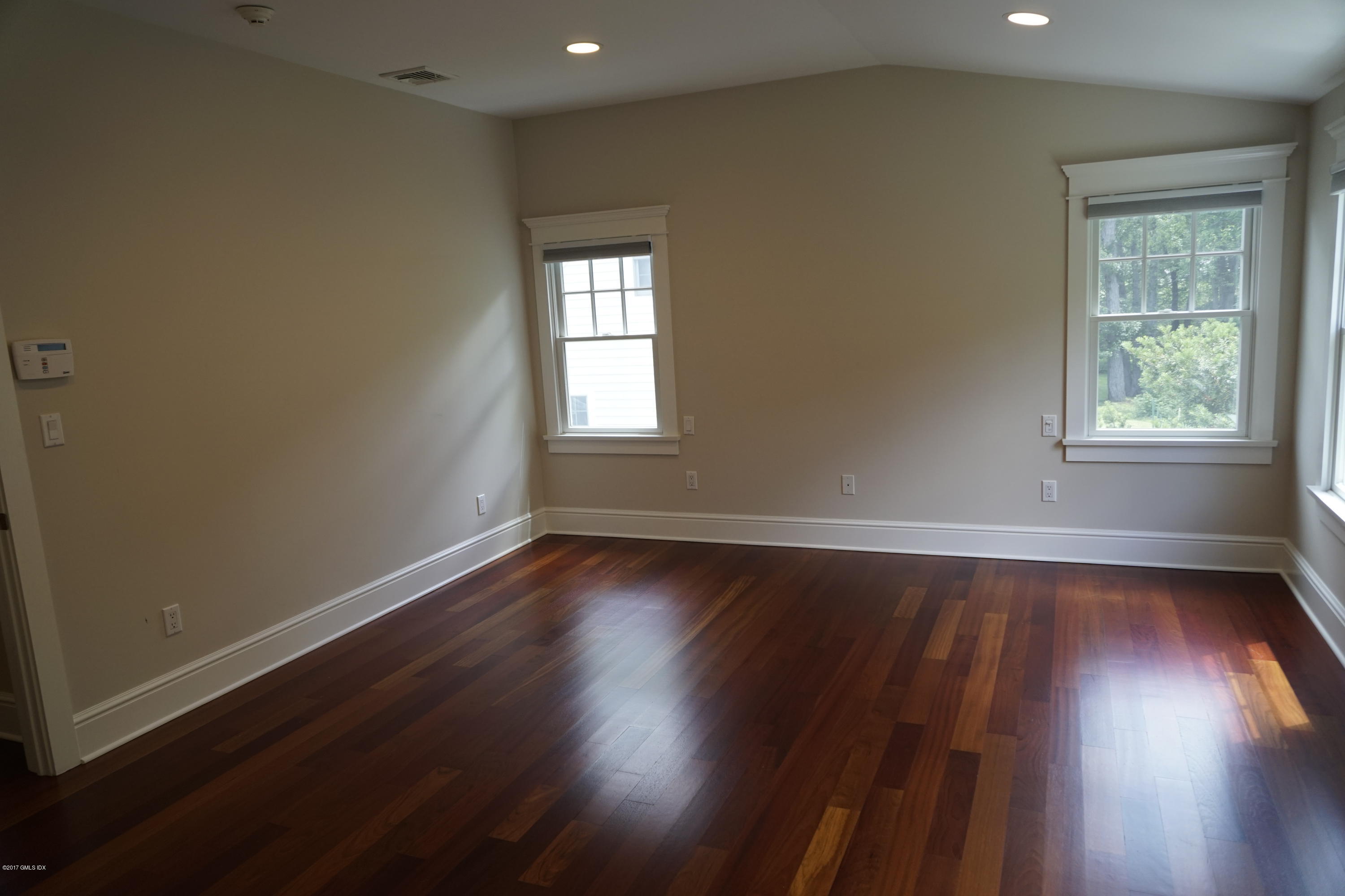 12 Birdsong Place Riverside, CT 06878 - Photo 12 of 30 an empty room with wooden floor and windows