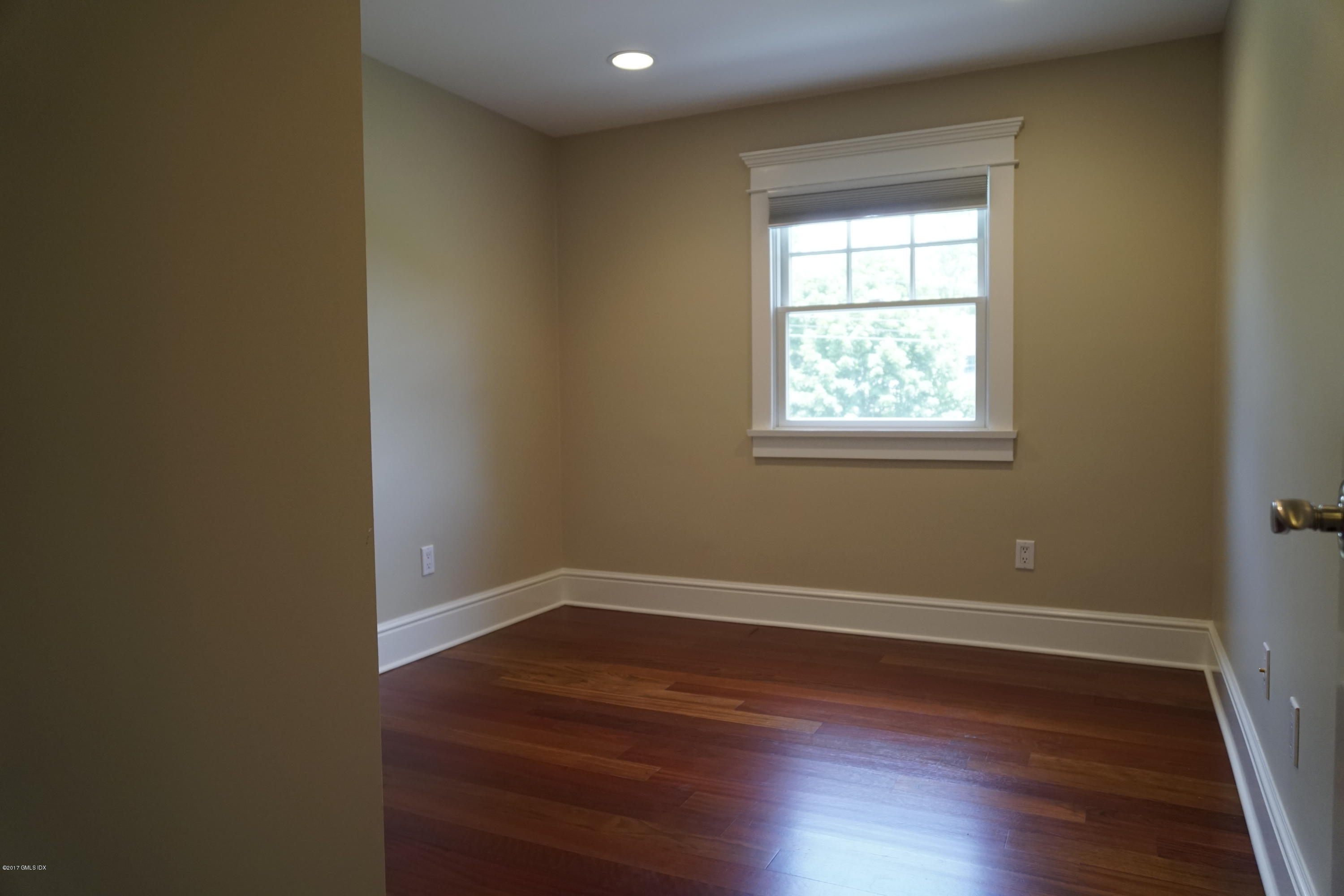 12 Birdsong Place Riverside, CT 06878 - Photo 15 of 30 an empty room with wooden floor and windows