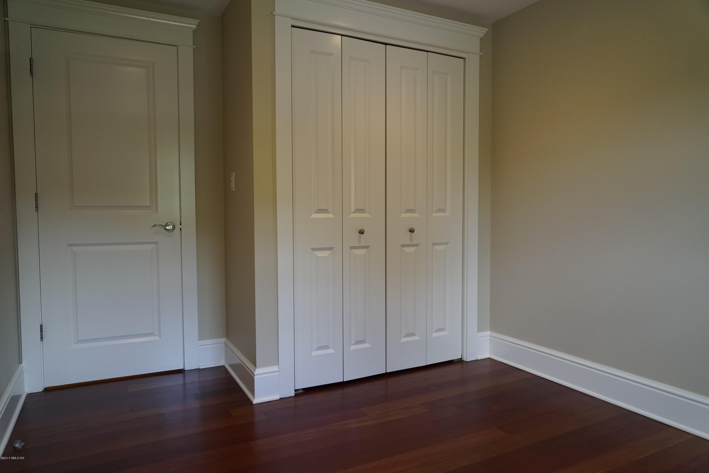 12 Birdsong Place Riverside, CT 06878 - Photo 16 of 30 a view of an empty room with wooden floor
