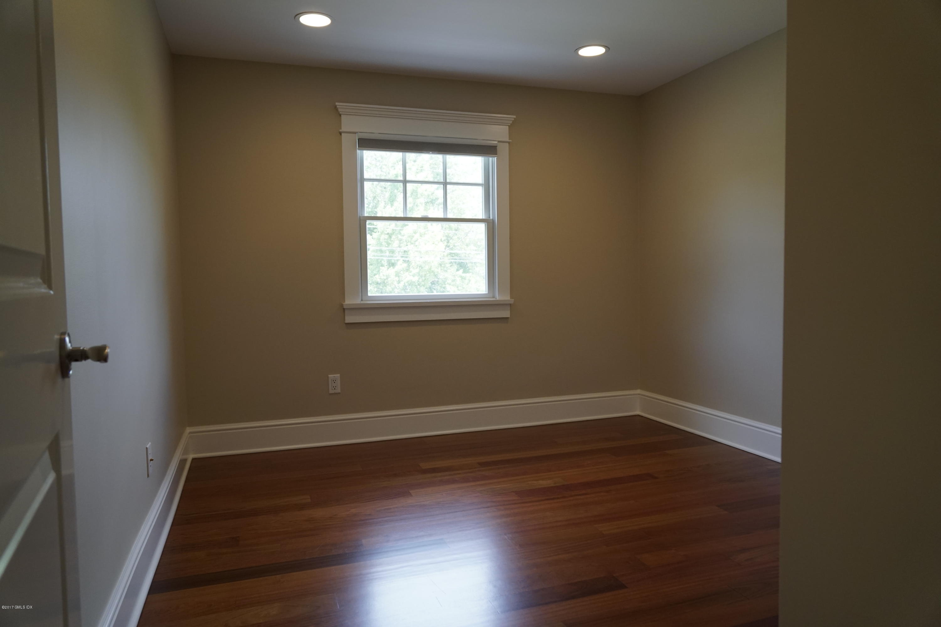 12 Birdsong Place Riverside, CT 06878 - Photo 17 of 30 an empty room with wooden floor and windows