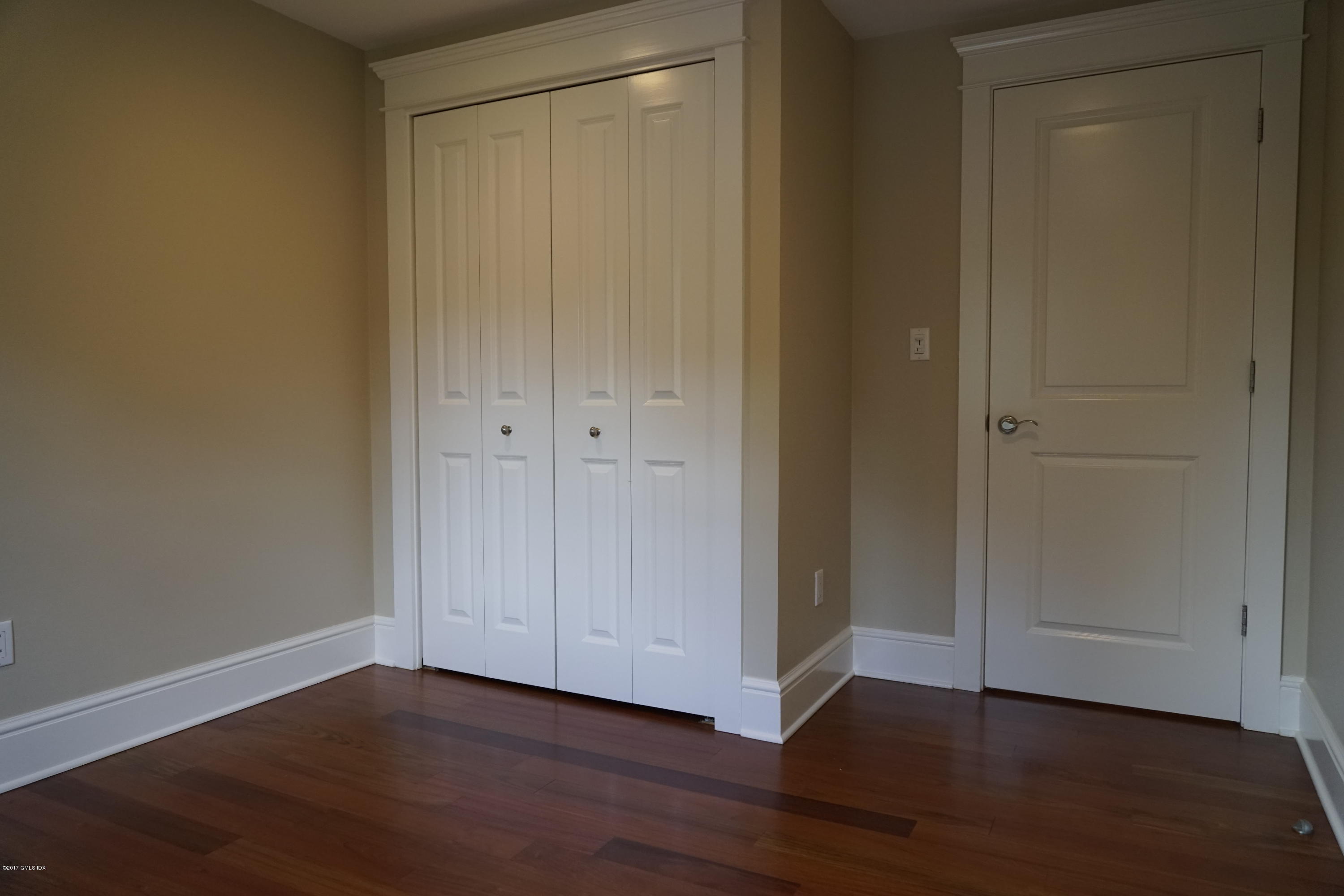 12 Birdsong Place Riverside, CT 06878 - Photo 18 of 30 a view of an empty room and wooden floor
