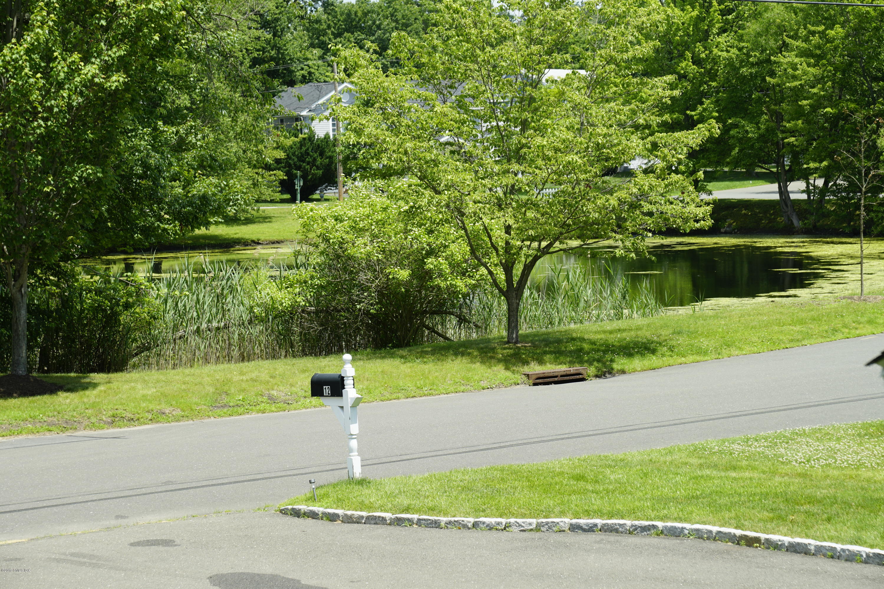 12 Birdsong Place Riverside, CT 06878 - Photo 2 of 30 a view of a park with large trees