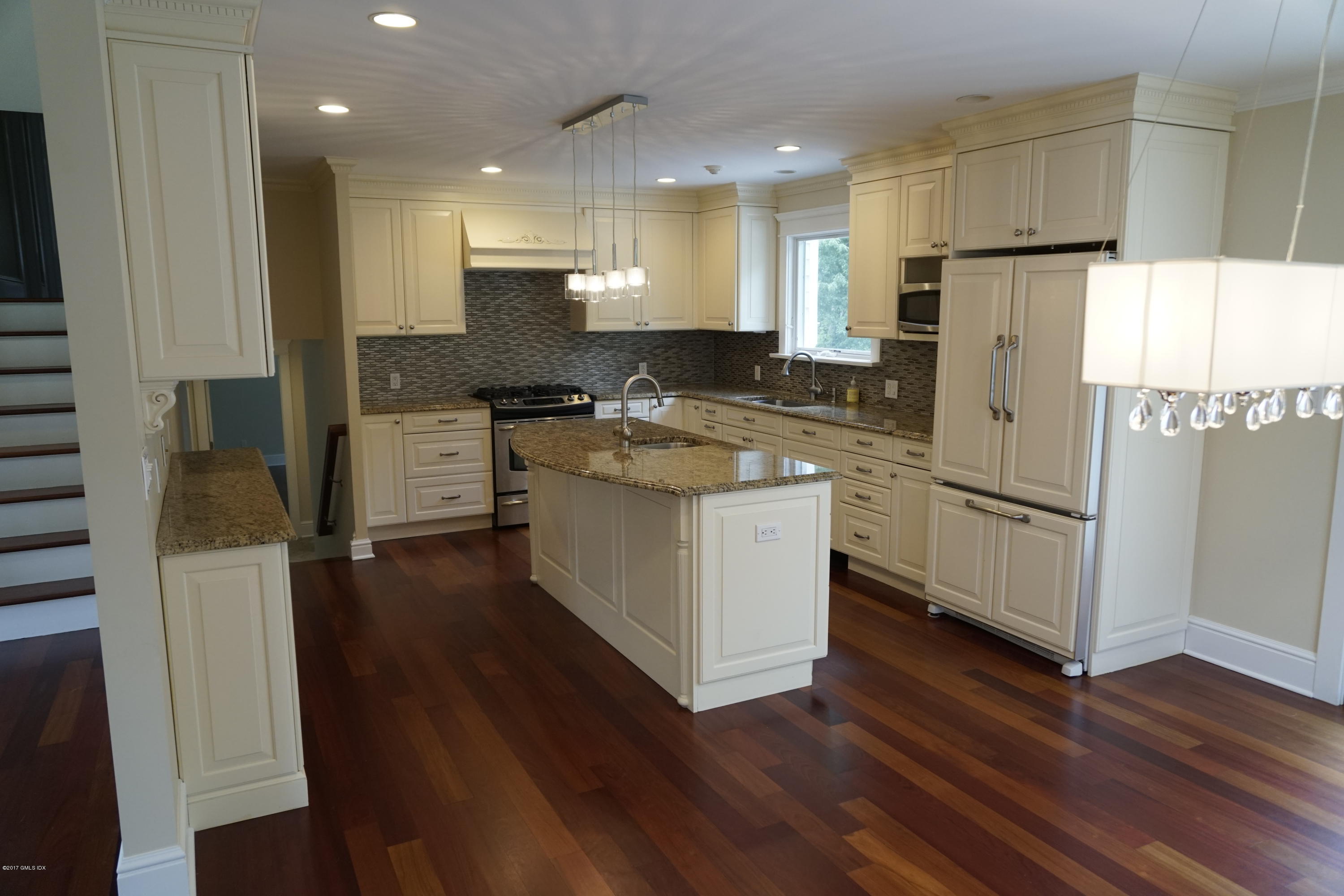 12 Birdsong Place Riverside, CT 06878 - Photo 4 of 30 a kitchen with stainless steel appliances granite countertop a refrigerator a sink dishwasher a stove and white countertops with wooden floor
