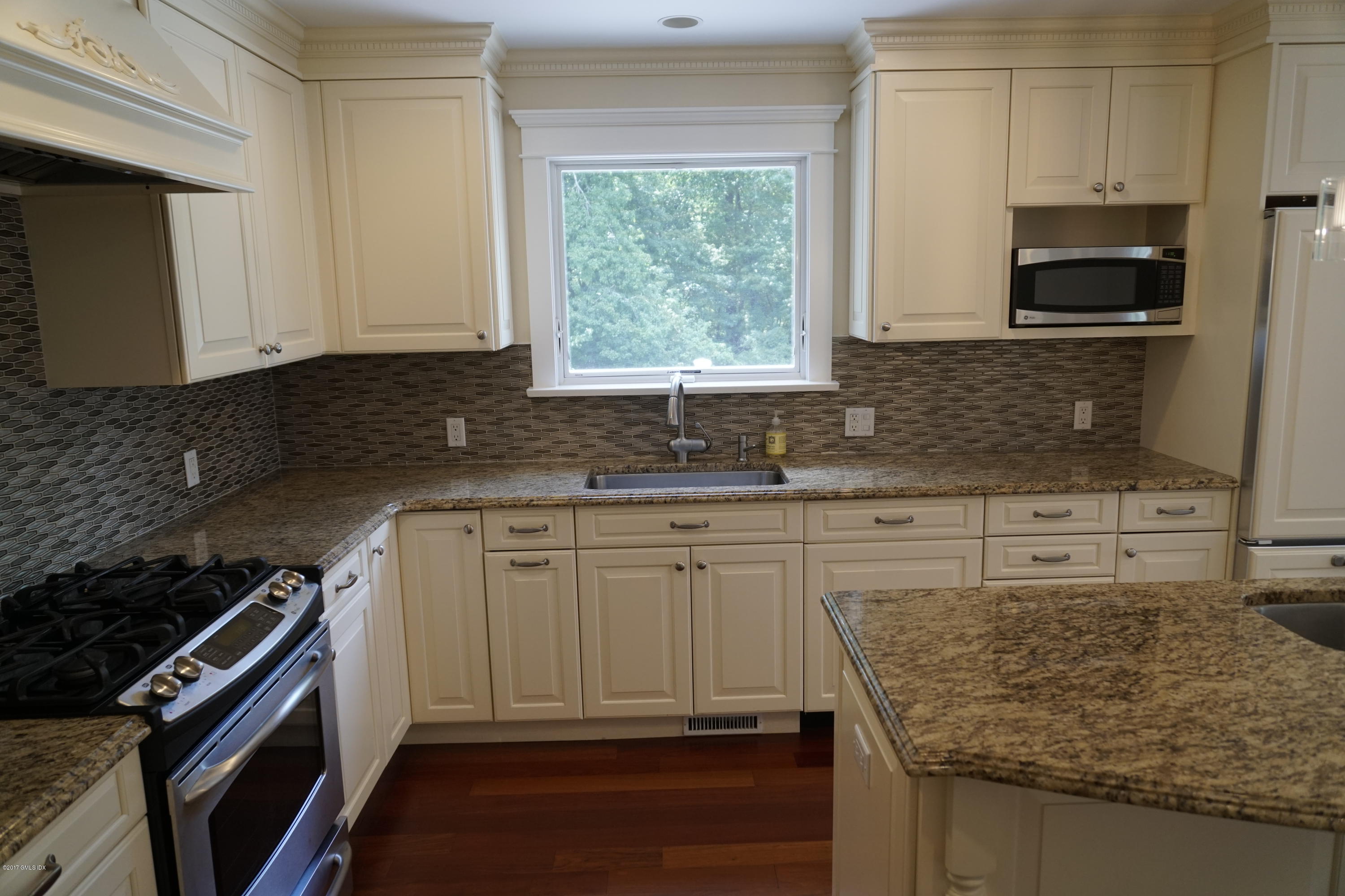 12 Birdsong Place Riverside, CT 06878 - Photo 6 of 30 a kitchen with granite countertop a sink stove and cabinets