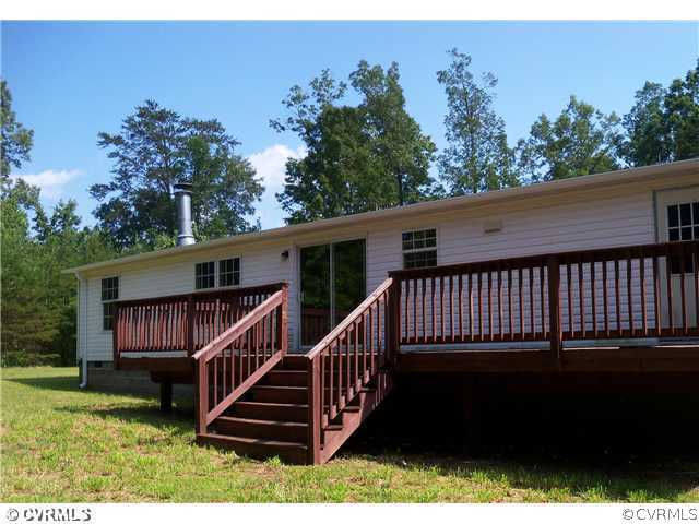 3737 Cedar Lane Road Kents Store, VA 23084 - Photo 2 of 10 a view of a house with a yard deck and a garden