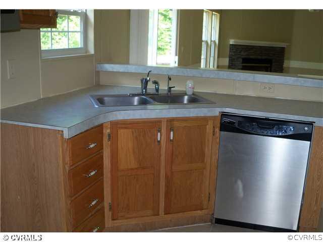 3737 Cedar Lane Road Kents Store, VA 23084 - Photo 10 of 10 a kitchen with stainless steel appliances granite countertop a sink and a refrigerator