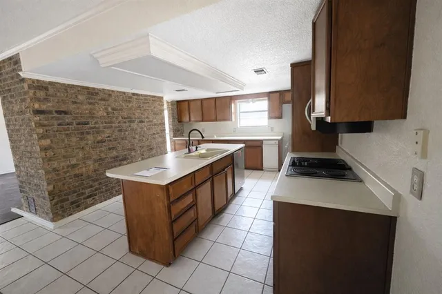 a kitchen with a stove cabinets and a sink