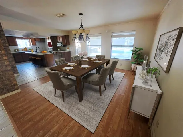 a view of a dining room with furniture and a chandelier