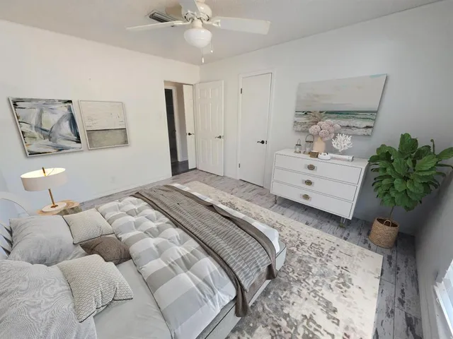 a bedroom with a bed and a potted plant