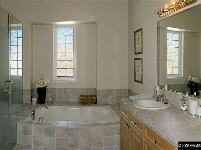 6808 Marble Canyon Road Reno, NV 89511 - Photo 7 of 9 a bathroom with a granite countertop sink a mirror and a bathtub