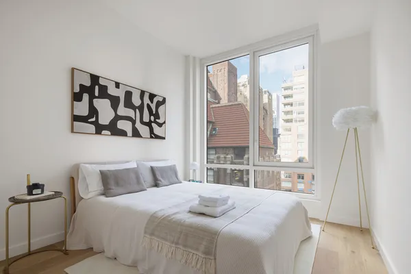 a bedroom with a large bed and a large window