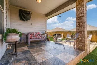 a view of a chairs and table in patio