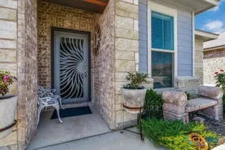 a front view of a house with a flower garden