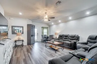 a living room with furniture and wooden floor