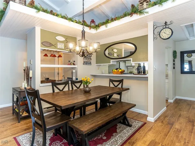 a view of a dining room with furniture and chandelier
