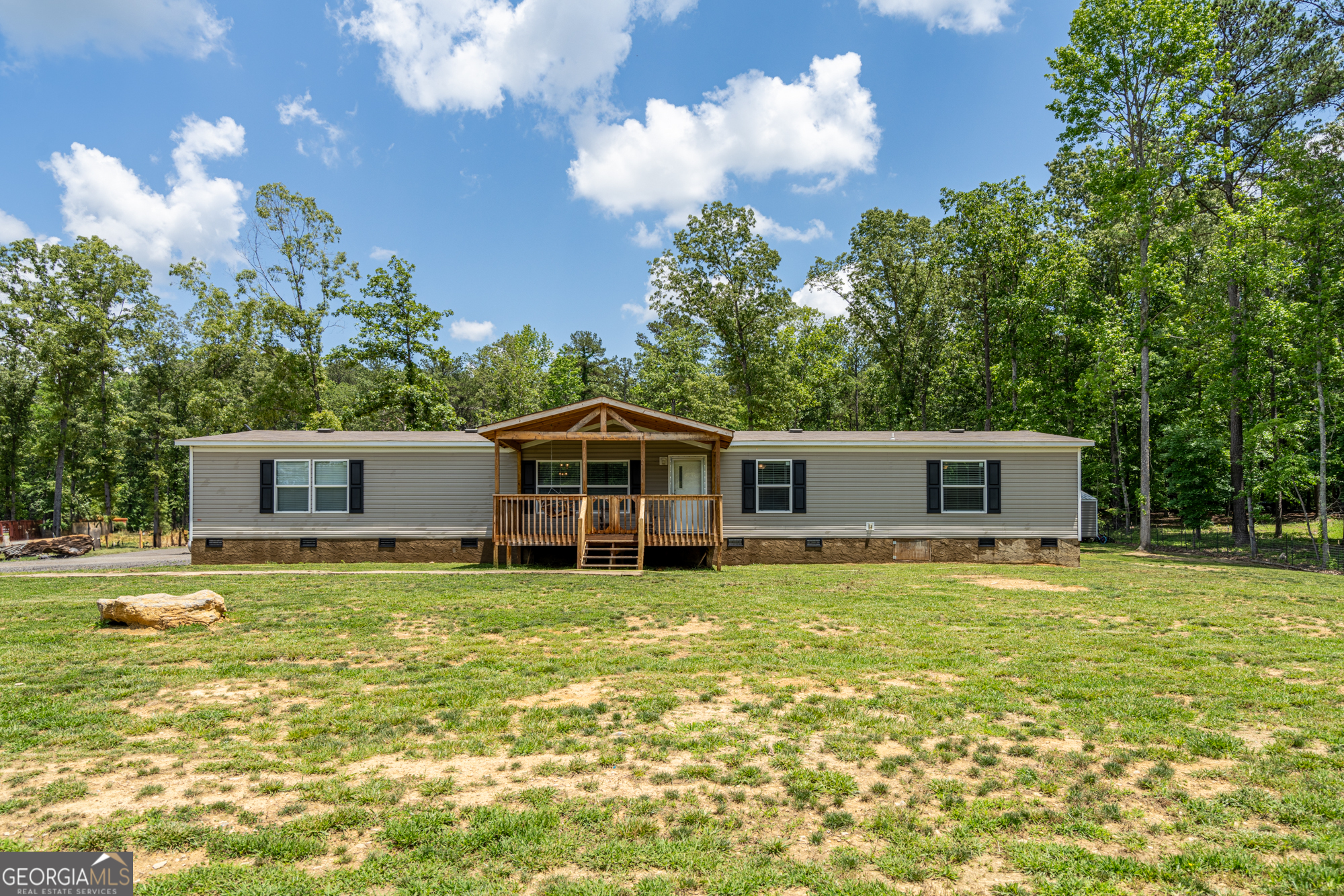 386 McGee Bend Road Southwest Cave Spring, GA 30124 - Photo 1 of 1 a white house that has a big yard and large trees