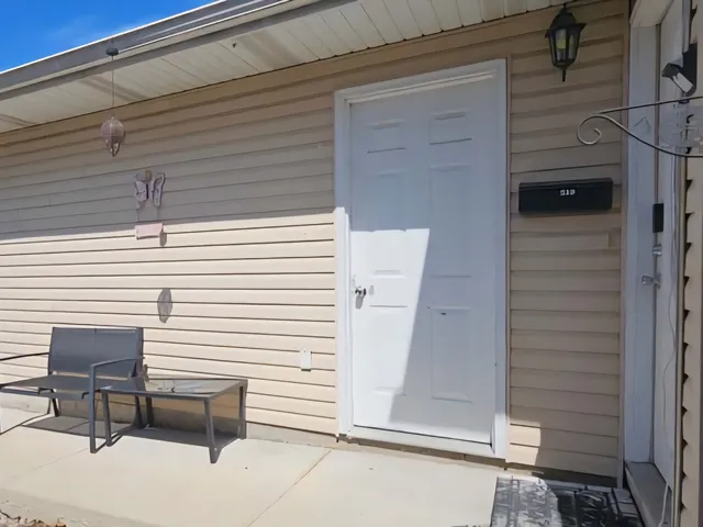 a living room with furniture a rug and a flat screen tv