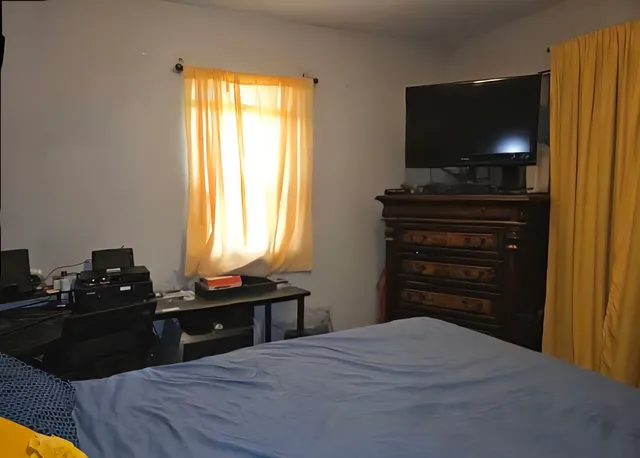 a view of storage and utility room with fridge