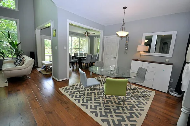a living room with furniture and a wooden floor
