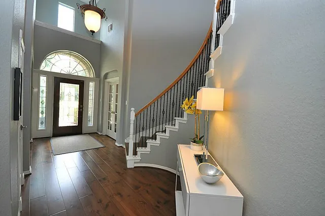 a view of entryway and hall with wooden floor
