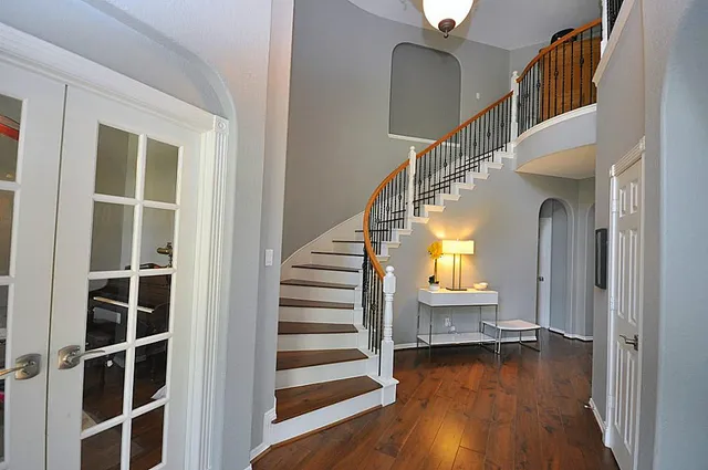 a view of entryway and hall with wooden floor