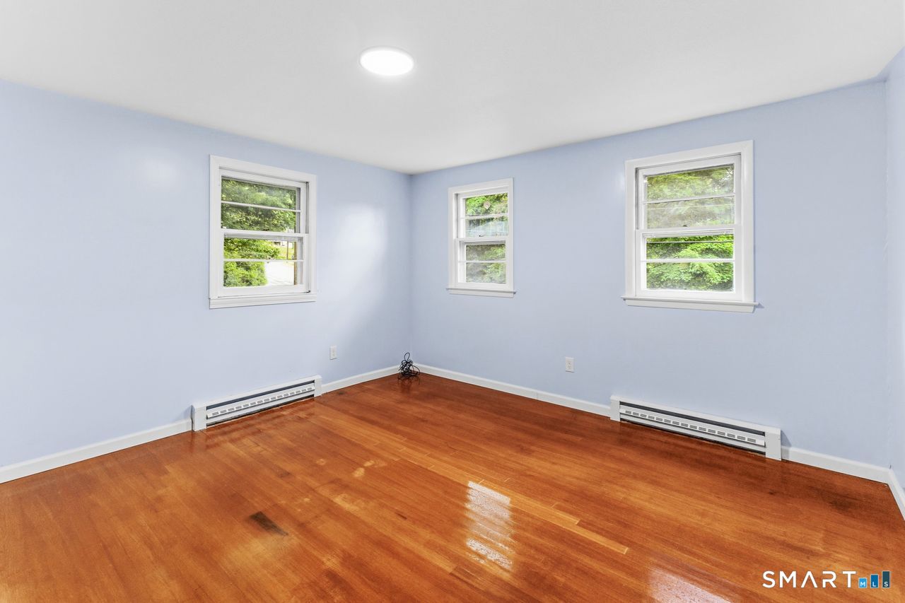 17 Rhoda Lane Bristol, CT 06010 - Photo 11 of 22 wooden floor in an empty room with a window