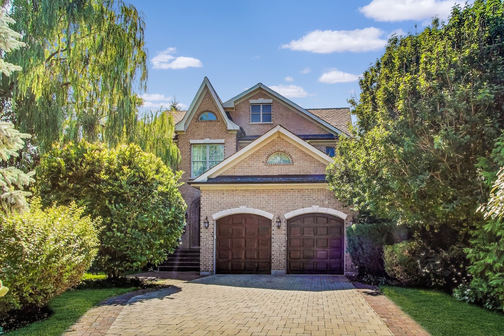 a front view of a house with a garden