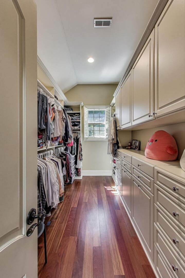 901 Pontiac Road Wilmette, IL 60091 - Photo 14 of 35 a kitchen with wooden floors and white cabinets