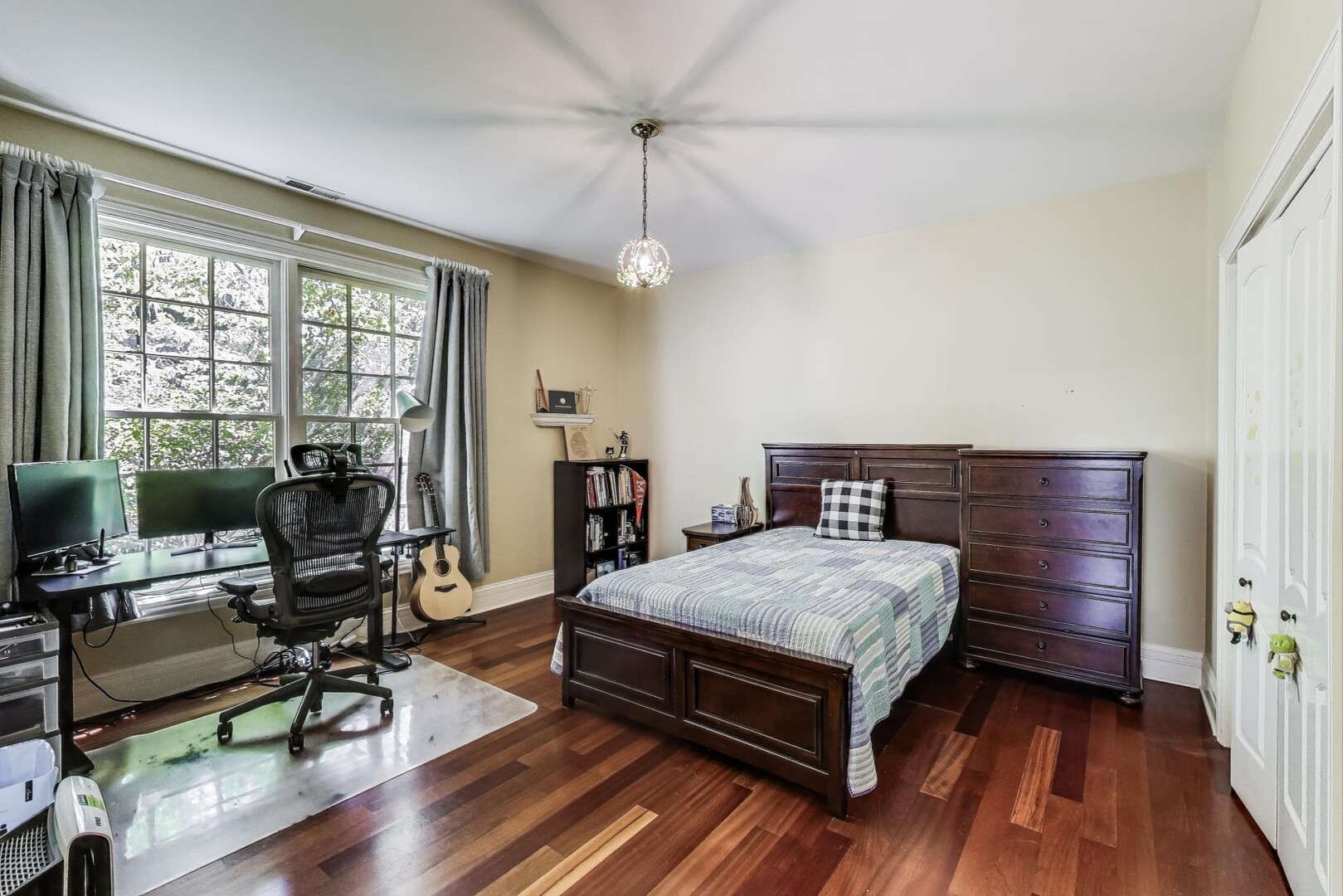 901 Pontiac Road Wilmette, IL 60091 - Photo 17 of 35 a bedroom with a bed and wooden floor