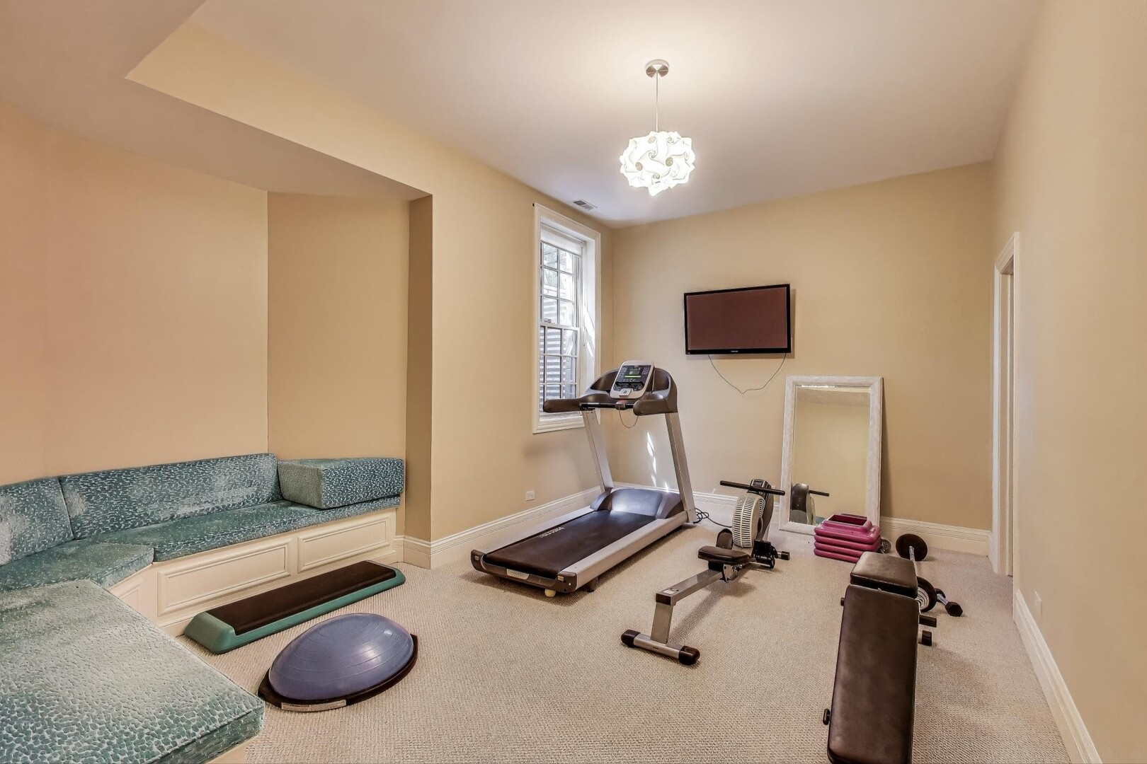901 Pontiac Road Wilmette, IL 60091 - Photo 25 of 35 a room with gym equipment and a flat screen tv