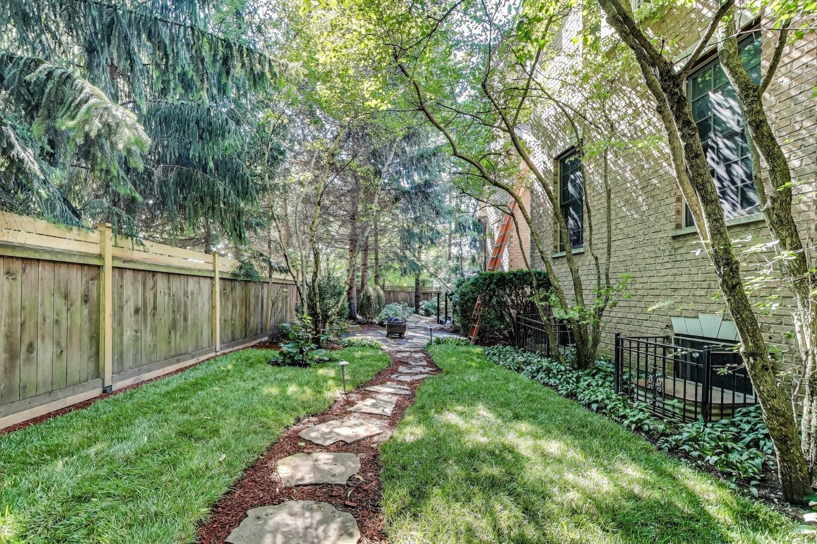 901 Pontiac Road Wilmette, IL 60091 - Photo 30 of 35 a backyard of a house with lots of green space and fountain